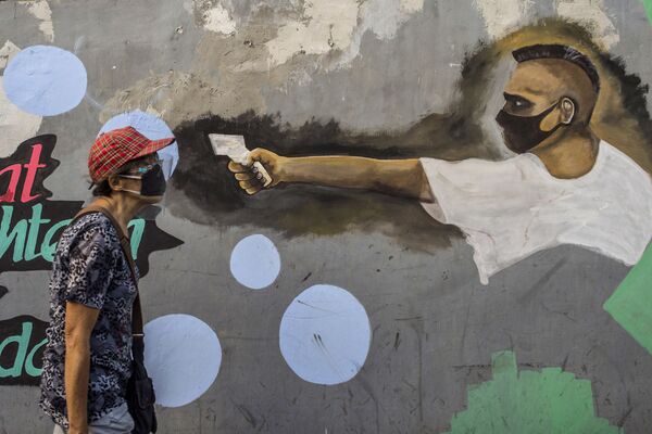 گرافیتی مردی با تب سنج در جزیره جاوه اندونزی - اسپوتنیک افغانستان  