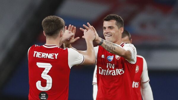 Soccer Football - FA Cup Semi Final - Arsenal v Manchester City - Wembley Stadium, London, Britain - July 18, 2020 Arsenal's Granit Xhaka and Kieran Tierney celebrate after the match, as play resumes behind closed doors following the outbreak of the coronavirus disease (COVID-19) - اسپوتنیک افغانستان  