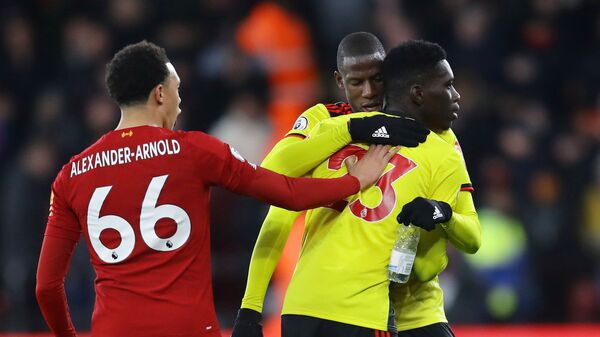 Soccer Football - Premier League - Watford v Liverpool - Vicarage Road, Watford, Britain - February 29, 2020  Liverpool's Trent Alexander-Arnold clashes with Watford's Ismaila Sarr and Abdoulaye Doucoure  - اسپوتنیک افغانستان  