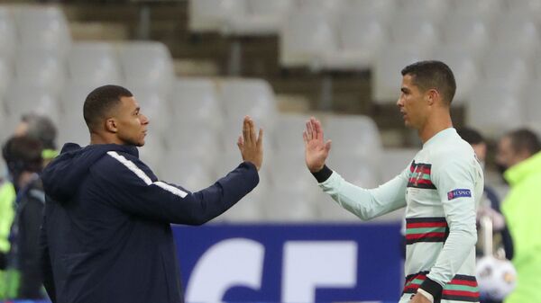 FILE - In this Sunday, Oct. 11, 2020 file photo France's Kylian Mbappe and Portugal's Cristiano Ronaldo, right, greet each other before the UEFA Nations League soccer match between France and Portugal at the Stade de France in Saint-Denis, north of Paris, France - اسپوتنیک افغانستان  