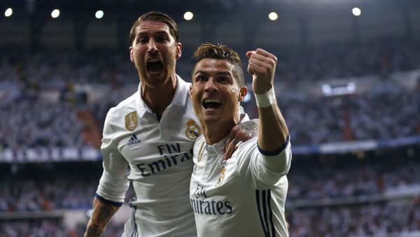 Real Madrid's Cristiano Ronaldo celebrates with Real Madrid's Sergio Ramos after scoring the opening goal during the Champions League semifinals first leg soccer match between Real Madrid and Atletico Madrid at Santiago Bernabeu stadium in Madrid, Spain, Tuesday May 2, 2017 - اسپوتنیک افغانستان  