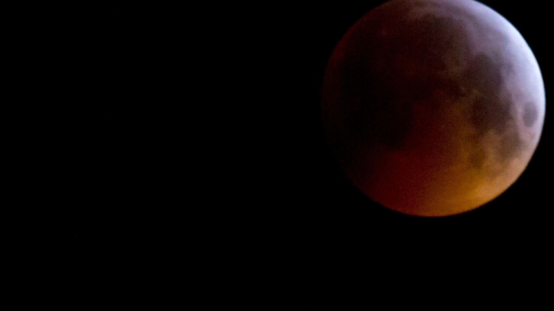 The Super Blood Wolf Moon eclipse in Antwerp, Belgium, Monday, Jan. 21, 2019. The eclipse takes place when the full moon is at or near the closest point in its orbit to Earth, a time popularly known as a supermoon. This means the Moon is deeper inside the umbra shadow and therefore may appear darker. - اسپوتنیک افغانستان  , 1920, 13.07.2022