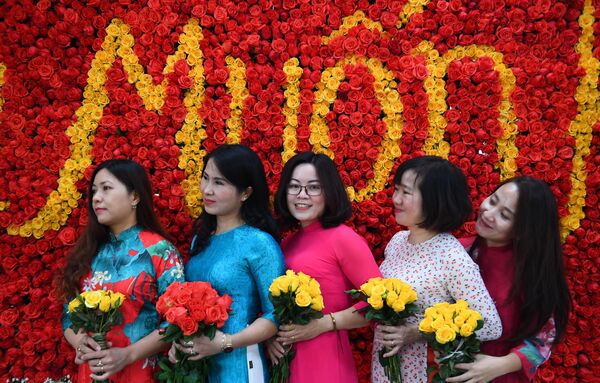 زنان در جریان جشنواره گلها در منطقه Me Linh در حومه هانوی در 9 دسامبر 2022 عکس می گیرند. - اسپوتنیک افغانستان  