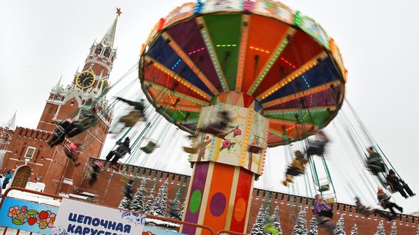 Посетители предновогодней ГУМ-Ярмарки катаются на карусели на Красной площади в Москве - اسپوتنیک افغانستان  