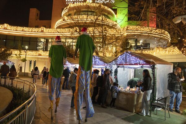  فلسطینی ها در حین خرید تحفه در بازار سنتی کریسمس  در شهر رام الله  - اسپوتنیک افغانستان  
