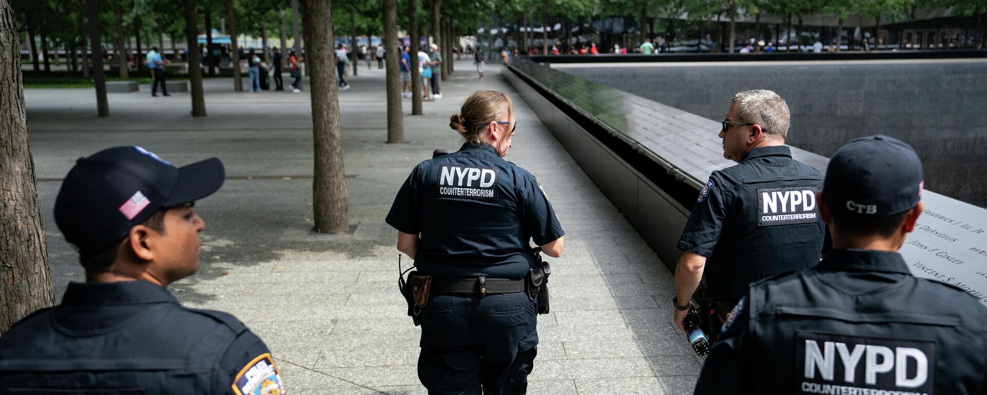 NYPD officer Michael Dougherty, a 25-year veteran, second from right, patrols with his colleagues beside the south reflecting pool of the 9/11 Memorial & Museum where names of his deceased colleagues and friends are displayed, Monday, Aug. 16, 2021, in New York.  - اسپوتنیک افغانستان  , 1920, 02.01.2023