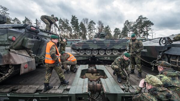 German soldiers load armored vehicles of the type Marder on a train at the troop exercise area in Grafenwoehr, southern Germany, on February 21, 2017. - اسپوتنیک افغانستان  