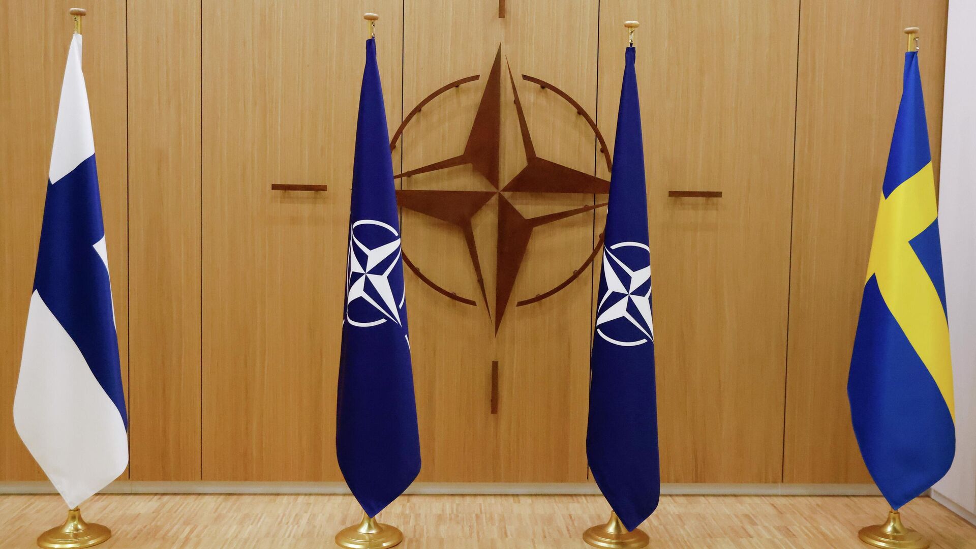 Flags of Finland, left, NATO and Sweden, right, are displayed during a ceremony to mark Sweden's and Finland's application for membership in Brussels, Belgium, Wednesday May 18, 2022. NATO Secretary-General Jens Stoltenberg said that the military alliance stands ready to seize a historic moment and move quickly on allowing Finland and Sweden to join its ranks, after the two countries submitted their membership requests. (Johanna Geron/Pool via AP) - اسپوتنیک افغانستان  , 1920, 21.10.2023
