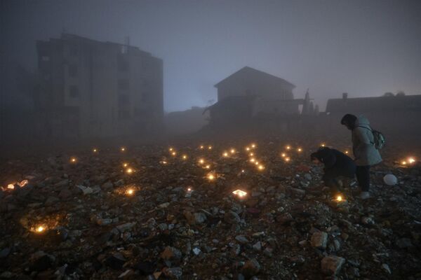 بازماندگان زلزله 6 فیبروری 2023 که شمال سوریه و ترکیه را ویران کرد، در مراسم یادبود با شمع های روشن در دست. - اسپوتنیک افغانستان  