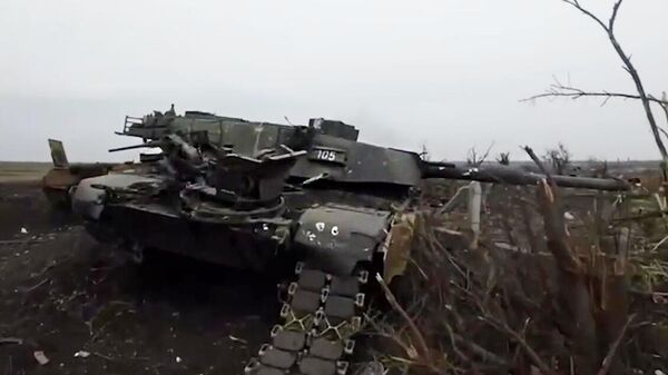 In this handout video grab released by the Russian Defence Ministry, a US-made Abrams tank used by the Ukrainian military, which was destroyed during fighting in the Avdeyevka area amid Russia's military operation in Ukraine, is seen in the field in the village of Berdychi, Donetsk People's Republic, Russia - اسپوتنیک افغانستان  
