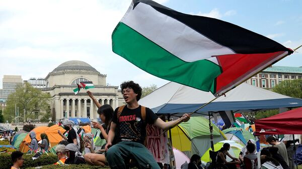 Протестующие размахивают палестинскими флагами на Западной лужайке Колумбийского университета в Нью-Йорке - اسپوتنیک افغانستان  