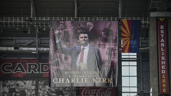 A banner for conservative activist Charlie Kirk is seen during a memorial service for Kirk - اسپوتنیک افغانستان  