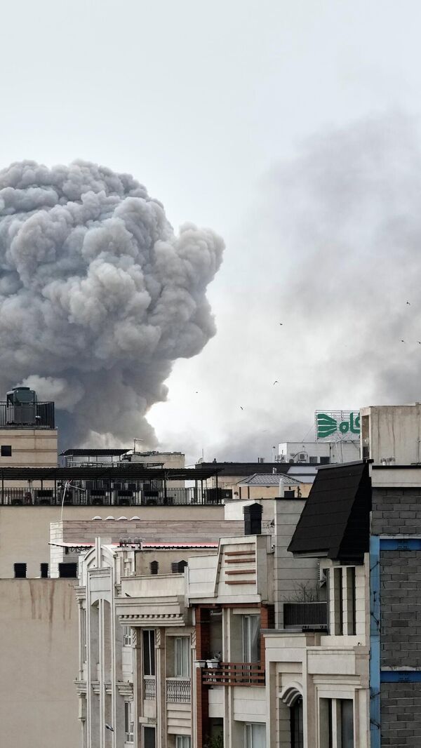 A plume of smoke rises after a strike in Tehran, Iran, Monday, March 2, 2026. (AP Photo/Vahid Salemi) - اسپوتنیک افغانستان  