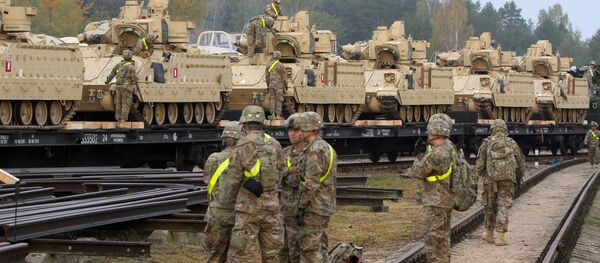 Members of the US Army 1st Brigade, 1st Cavalry Division, unload heavy combat equipment including Bradley Fighting Vehicles at the railway station near the Rukla military base in Lithuania, on October 4, 2014 Members of the US Army 1st Brigade, 1st Cavalry Division, unload heavy combat equipment including Bradley Fighting Vehicles at the railway station near the Rukla military base in Lithuania, on October 4, 2014 - اسپوتنیک افغانستان