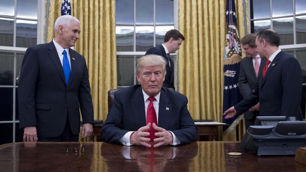 US President Donald Trump (C) waits at his desk before signing confirmations for James Mattis as US Secretary of Defense and John Kelly as US Secretary of Homeland Security, as Vice President Mike Pence (L) and White House Chief of Staff Reince Priebus (R) look on, in the Oval Office of the White House in Washington, DC, January 20, 2017 - اسپوتنیک افغانستان  