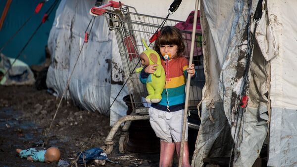 Ребенок курдских мигрантов возле палатки в лагере беженцев под Дюнкерком, Франция - اسپوتنیک افغانستان  