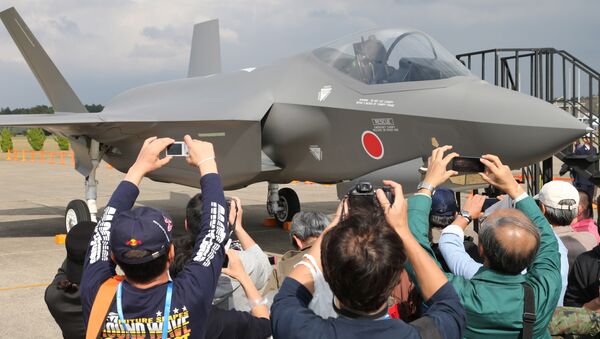 Visitors photograph a mock-up of the F-35 fighter jet displayed at the annual Self-Defense Forces Commencement of Air Review at Hyakuri Air Base, north of Tokyo, Sunday, Oct. 26, 2014 - اسپوتنیک افغانستان  