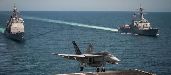 An F/A-18E Super Hornet lands on the flight deck of the U.S. Navy aircraft carrier USS Carl Vinson as the Ticonderoga-class guided-missile cruiser USS Lake Champlain (L) and the Arleigh Burke-class guided-missile destroyer USS Wayne E. Meyer transit the western Pacific Ocean May 3, 2017. An F/A-18E Super Hornet lands on the flight deck of the U.S. Navy aircraft carrier USS Carl Vinson as the Ticonderoga-class guided-missile cruiser USS Lake Champlain (L) and the Arleigh Burke-class guided-missile destroyer USS Wayne E. Meyer transit the western Pacific Ocean May 3, 2017. - اسپوتنیک افغانستان