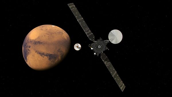 The ExoMars Trace Gas Orbiter and its entry, descent and landing demonstrator module, Schiaparelli, approaching Mars. - اسپوتنیک افغانستان  