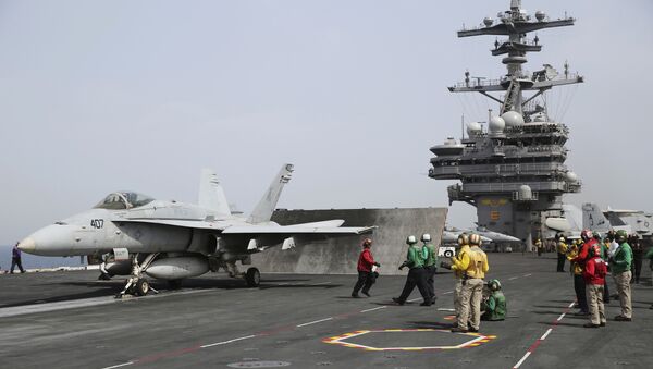 In this Wednesday, March 22, 2017 photograph, sailors prepare to launch an F-18 off of the USS George H.W. Bush as it travels through the Persian Gulf. - اسپوتنیک افغانستان  