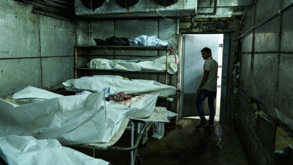 In this photograph taken on November 4, 2015, an Indian medic walks through a cold storage unit as he inspects a morgue in New Delhi - اسپوتنیک افغانستان  