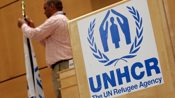 A staff installs a UNHCR flag close to a logo of UN High Commissioner for Refugees (UNHCR) prior to the opening of a two-day United Nations conference trying to boost support for Iraqis who have fled violence, 17 April 2007 at the UN Office in Geneva - اسپوتنیک افغانستان  