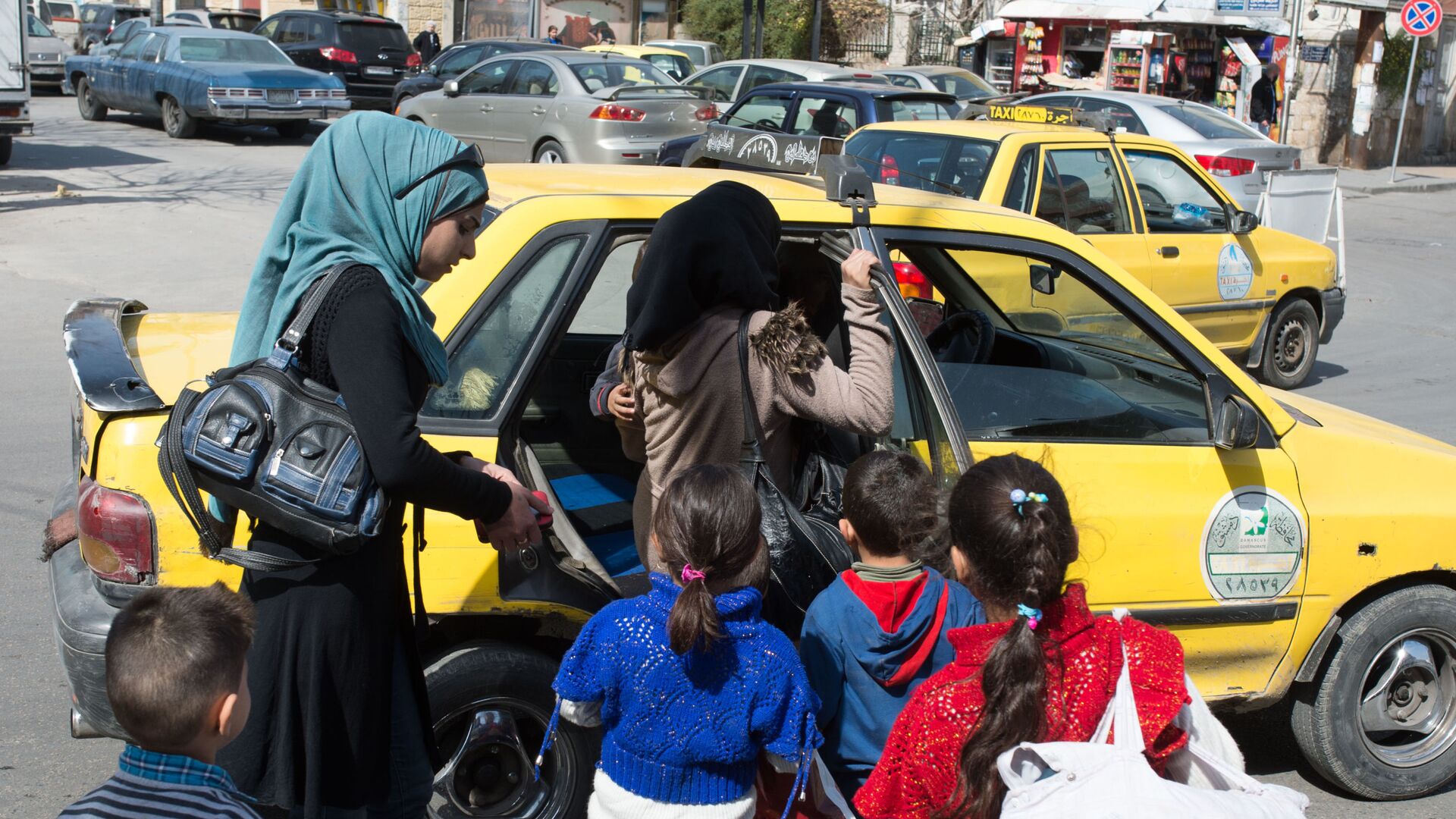 Женщины с детьми садятся в такси на одной из улиц Дамаска в первый день перемирия - اسپوتنیک افغانستان  , 1920, 17.05.2022