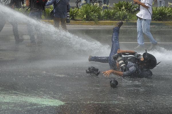 عکاس آسوشیتدپرس در شهر کاراکاس پایتخت ونزوئلا - اسپوتنیک افغانستان  