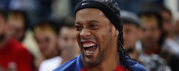 Former FC Barcelona player Ronaldinho, laughs as he enters the stadium during a friendly soccer match between the FC Barcelona and Real Madrid Legends, at the Camille Chamoun Sports City in Beirut, Lebanon, Friday,  Former FC Barcelona player Ronaldinho, laughs as he enters the stadium during a friendly soccer match between the FC Barcelona and Real Madrid Legends, at the Camille Chamoun Sports City in Beirut, Lebanon, Friday,  - اسپوتنیک افغانستان