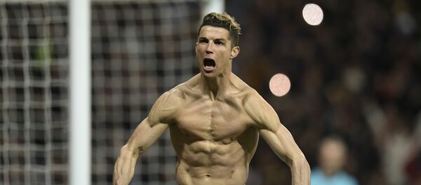 Real Madrid's Portuguese forward Cristiano Ronaldo celebrates after scoring a penalty during the UEFA Champions League quarter-final second leg football match between Real Madrid CF and Juventus FC at the Santiago Bernabeu stadium in Madrid on April 11, 2018. - اسپوتنیک افغانستان  