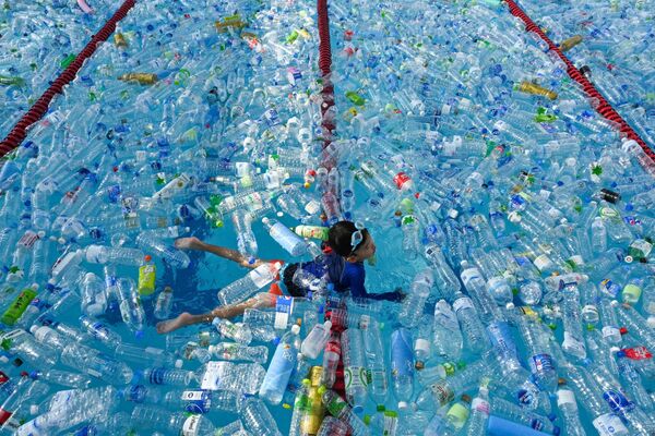 کودکی در حال شنا در حوضی پر از بوتل های پلاستیکی - اسپوتنیک افغانستان  