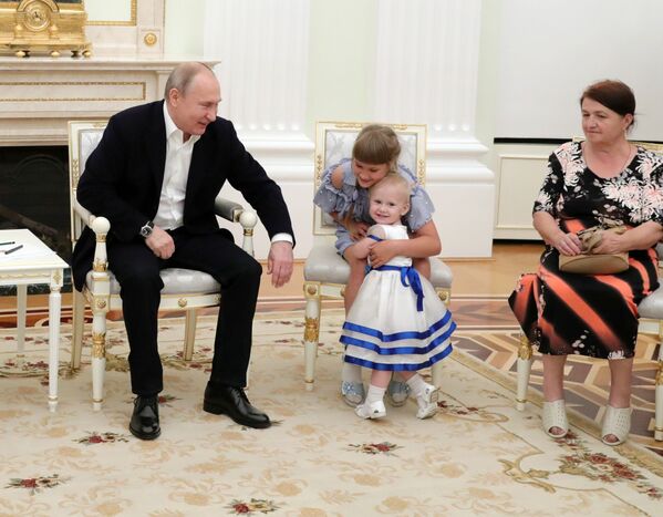 ولادیمیر پوتین رئیس جمهور روسیه در دیدار با خانواده سیل زدگان ایرکوتسک در کاخ کرملین - اسپوتنیک افغانستان  