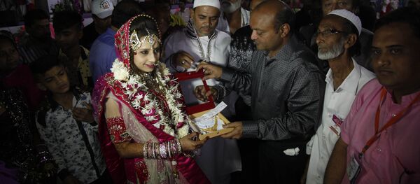 Индийский торговец алмазами Mahesh Savani дарит подарки мусульманской невесте Nagmabegum Qadri  во время массовой свадебной церемонии в городе Сурат, Индия - اسپوتنیک افغانستان  