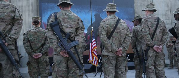 U.S. service members stand in front of a U.S. flag during a ceremony on the thirteenth anniversary of the 9/11 terrorist attacks in front of the World Trade Center Memorial at Bagram Airfield, Afghanistan, Thursday, Sept. 11, 2014 U.S. service members stand in front of a U.S. flag during a ceremony on the thirteenth anniversary of the 9/11 terrorist attacks in front of the World Trade Center Memorial at Bagram Airfield, Afghanistan, Thursday, Sept. 11, 2014 - اسپوتنیک افغانستان