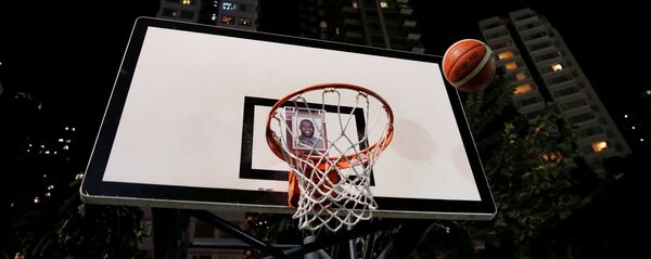 Protester throw basketballs at a hoop with NBA star Lebron James' photo during a gathering in support of NBA's Houston Rockets' team general manager Daryl Morey, who sent a tweet backing the pro-democracy movement, in Hong Kong, China, October 15, 2019 Protester throw basketballs at a hoop with NBA star Lebron James' photo during a gathering in support of NBA's Houston Rockets' team general manager Daryl Morey, who sent a tweet backing the pro-democracy movement, in Hong Kong, China, October 15, 2019 - اسپوتنیک افغانستان