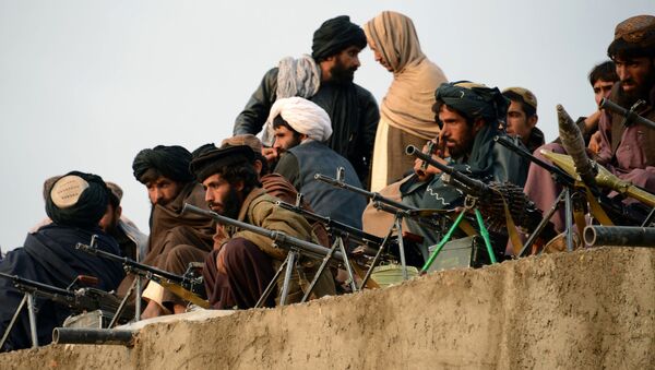 In this photograph taken on November 3, 2015, Afghan Taliban fighters listen to Mullah Mohammad Rasool Akhund (unseen), the newly appointed leader of a breakaway faction of the Taliban, at Bakwah in the western province of Farah - اسپوتنیک افغانستان  