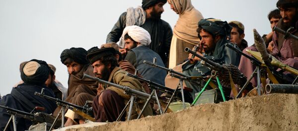 In this photograph taken on November 3, 2015, Afghan Taliban fighters listen to Mullah Mohammad Rasool Akhund (unseen), the newly appointed leader of a breakaway faction of the Taliban, at Bakwah in the western province of Farah In this photograph taken on November 3, 2015, Afghan Taliban fighters listen to Mullah Mohammad Rasool Akhund (unseen), the newly appointed leader of a breakaway faction of the Taliban, at Bakwah in the western province of Farah - اسپوتنیک افغانستان