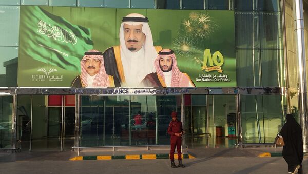 FILE -- In this Dec. 14, 2015 file photo, images of King Salman, center, Crown Prince Mohammed bin Nayef , left, and Deputy Crown Prince Mohammed bin Salman hang at the entrance of a shopping center in Riyadh, Saudi Arabia to mark the country's 85th anniversary - اسپوتنیک افغانستان  