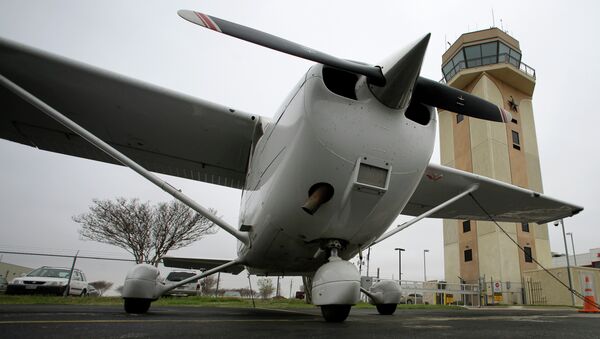 A Cessna aircraft is parked near by the air traffic control tower at the Collin County Regional Airport at McKinney Friday, March 22, 2013, in McKinney, Texas - اسپوتنیک افغانستان  