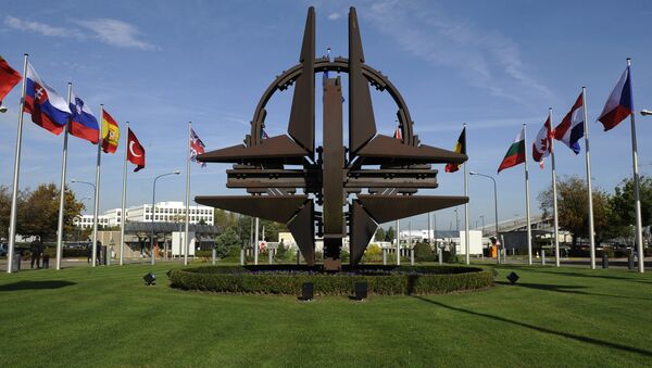 The NATO emblem is seen before a defence ministers meeting at the NATO headquarters in Brussels on October 22, 2013 - اسپوتنیک افغانستان  