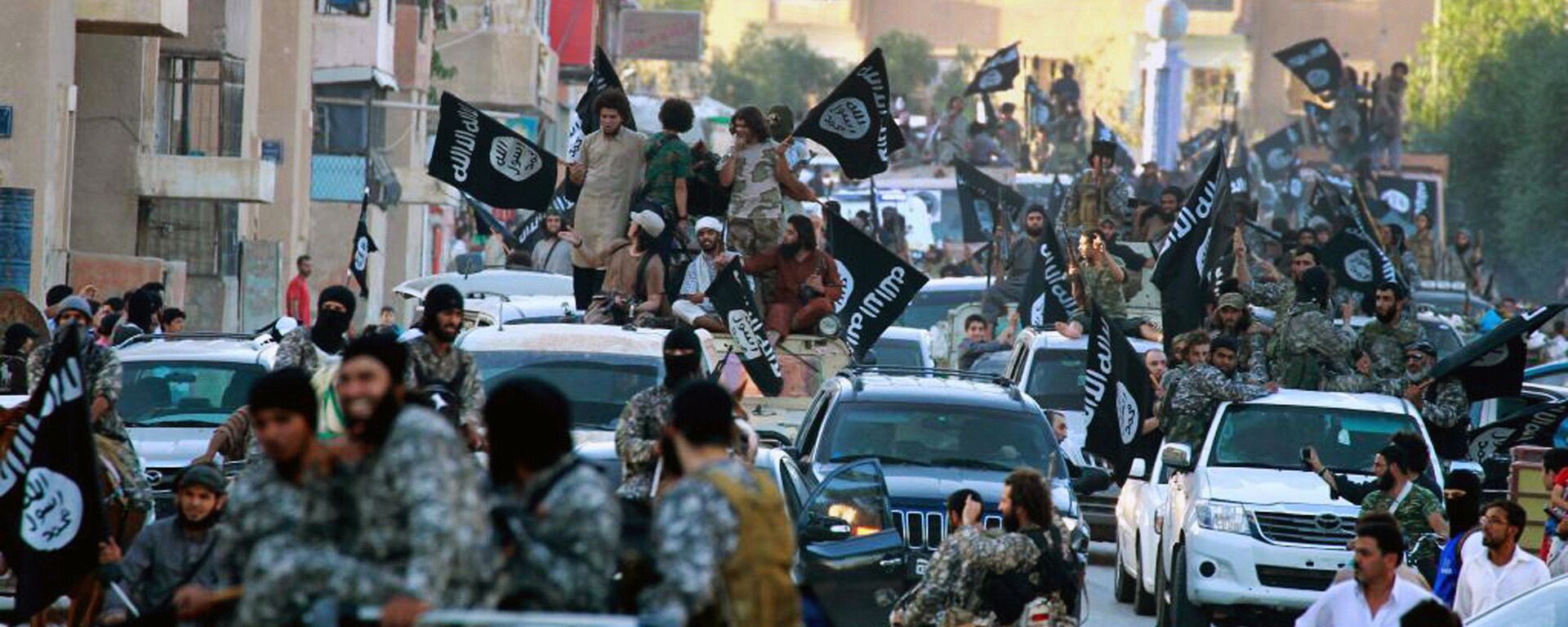 In this undated file image posted on Monday, June 30, 2014, by the Raqqa Media Center of the Islamic State group, a Syrian opposition group, which has been verified and is consistent with other AP reporting, fighters from the Islamic State group parade in Raqqa, north Syria - اسپوتنیک افغانستان  , 1920, 19.06.2023