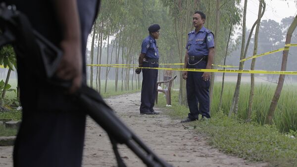 In this Oct. 4, 2015 file photo, Bangladeshi security officers stand by the site where Japanese citizen Kunio Hoshi was killed at Mahiganj village in Rangpur district, 300 kilometers (185 miles) north of Dhaka, Bangladesh - اسپوتنیک افغانستان  