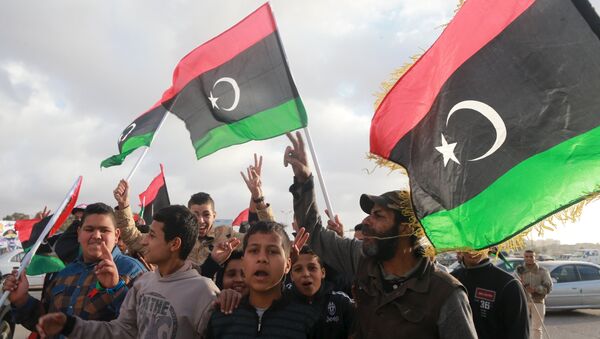 Libyans wave their national flags as they celebrate Libya's eastern government's gains in the area, in Benghazi, Libya, February 24, 2016. - اسپوتنیک افغانستان  