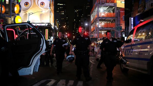 NYPD officers keep an eye on protesters as they go through Times Square taking part in a protest against the killing of Alton Sterling, Philando Castile and in support of Black Lives Matter during a march along Manhattan's streets in New York July 8, 2016. - اسپوتنیک افغانستان  