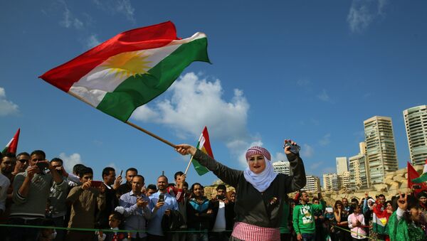 Syrian Kurd Nazdan who fled her home in Qamishli, Syria, wears traditional clothes as she dances and waves a Kurdish flag, during a celebration of Nowruz day, in Beirut, Lebanon, Monday, March 21, 2016 - اسپوتنیک افغانستان  