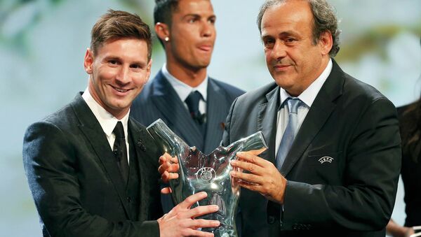 Barcelona's Lionel Messi (L) receives from UEFA President Michel Platini the Best Player UEFA 2015 Award during the draw ceremony for the 2015/2016 Champions League Cup soccer competition at Monaco's Grimaldi Forum while Cristiano Ronaldo (C) looks on in Monte Carlo August 27, 2015 - اسپوتنیک افغانستان  