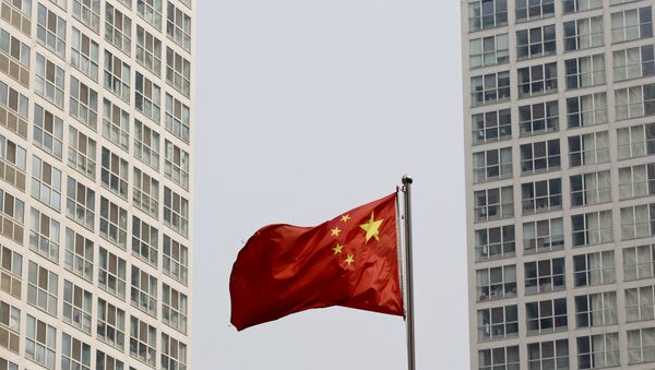 A Chinese national flag flutters in the wind in between a high-rise residential and office complex in Beijing, China. (File) A Chinese national flag flutters in the wind in between a high-rise residential and office complex in Beijing, China. (File) - اسپوتنیک افغانستان