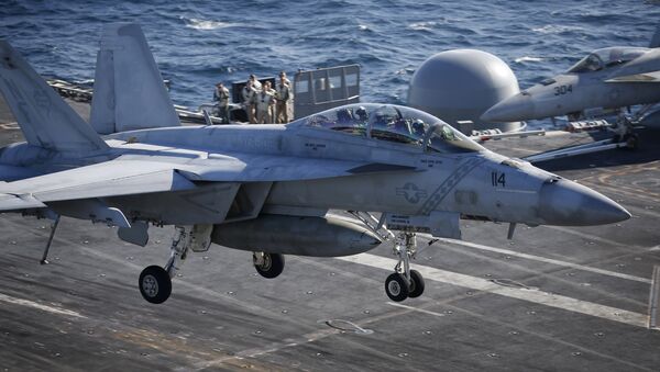 A U.S. Navy F/A-18 Super Hornet fighter lands onto the deck of the USS Ronald Reagan, a Nimitz-class nuclear-powered super carrier, during a joint naval drill between South Korea and the U.S. (File) - اسپوتنیک افغانستان  