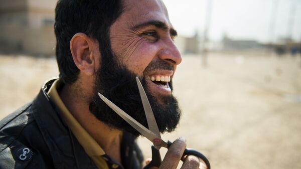 Иракский мужчина, добравшийся до правительственных войск в предместье Мосула, стрижет себе бороду - اسپوتنیک افغانستان  