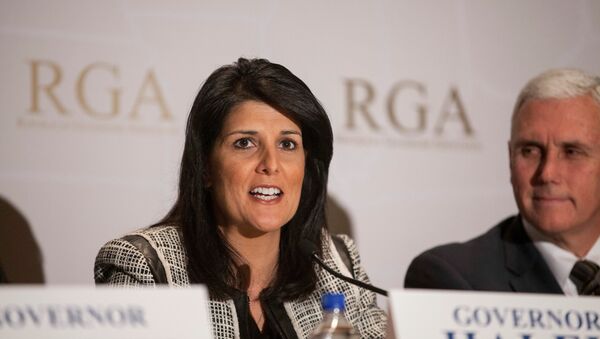 Governor Nikki Haley (R-SC) answers a question next to Governor Mike Pence (R-IN) (R) during a news briefing at the 2013 Republican Governors Association conference in Scottsdale, Arizona - اسپوتنیک افغانستان  